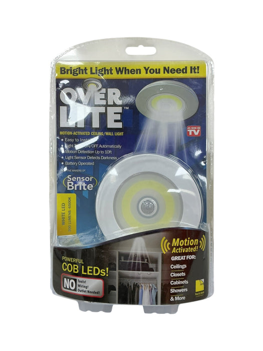 Over Lite - vista frontal en empaque blister azul/negro mostrando lámpara LED COB circular blanca